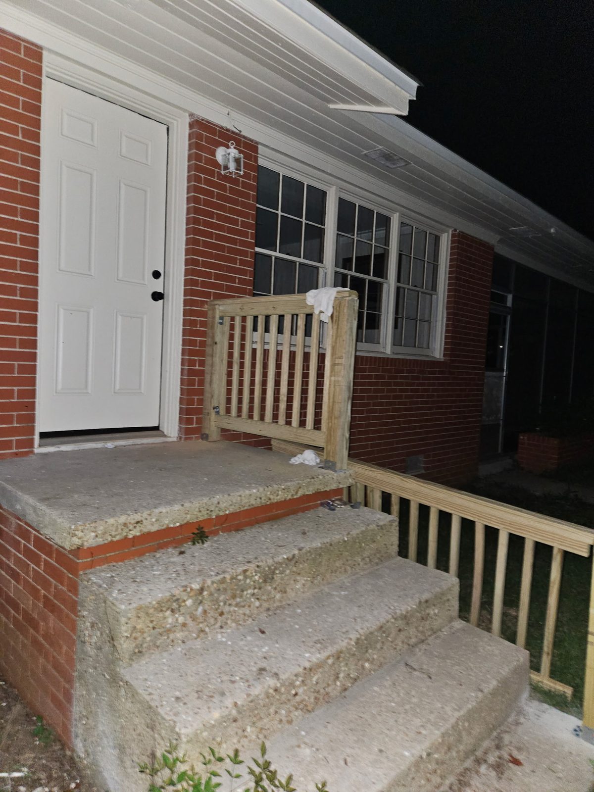 Freshly built pressure-treated porch railing, unpainted