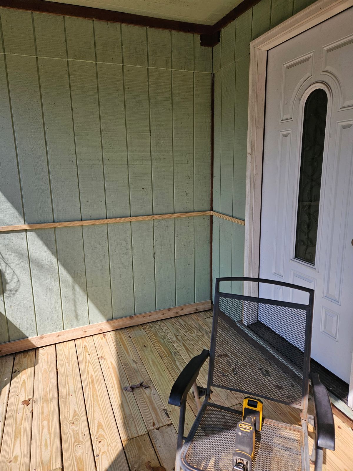 Finished screened porch — new floor, wainscot and chair-rail trim complete