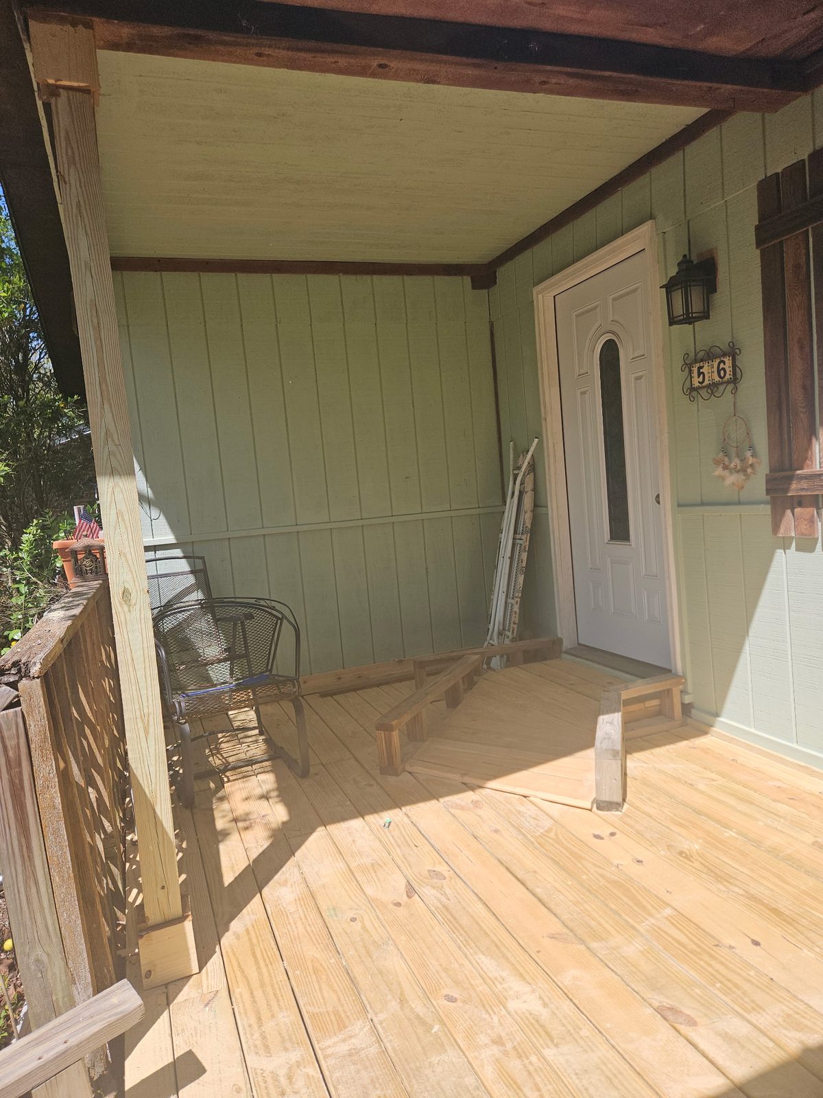 Newly built porch steps and entry with house number