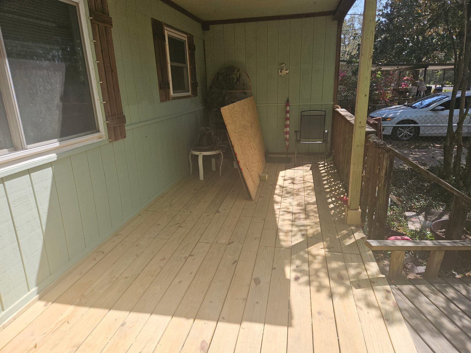 Rebuilt screened porch — full view with new flooring and custom shutters