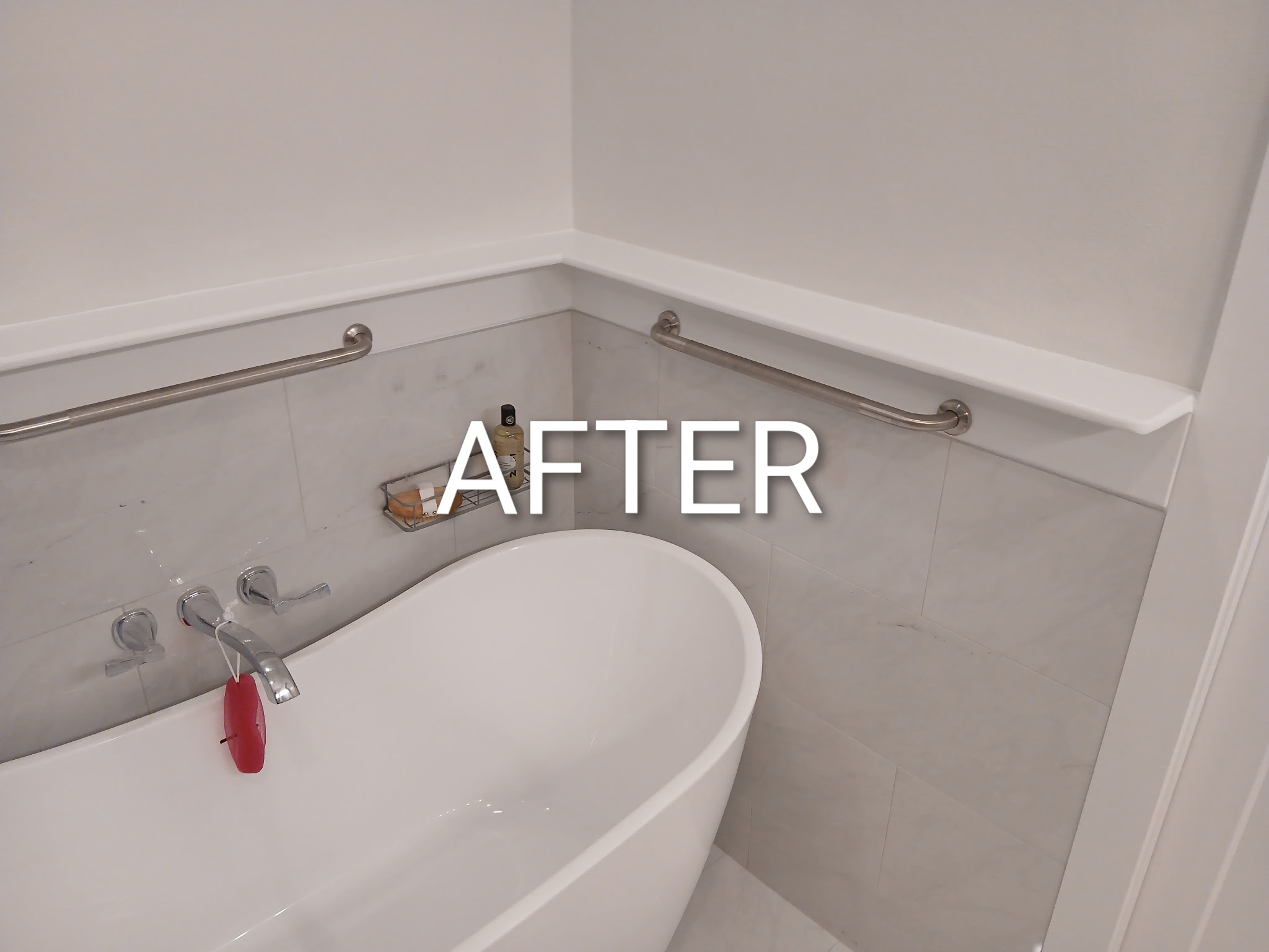 Bathroom after — clean trim, handicap rails installed